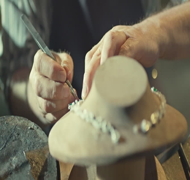 female jeweler hands repairing a pearls necklace