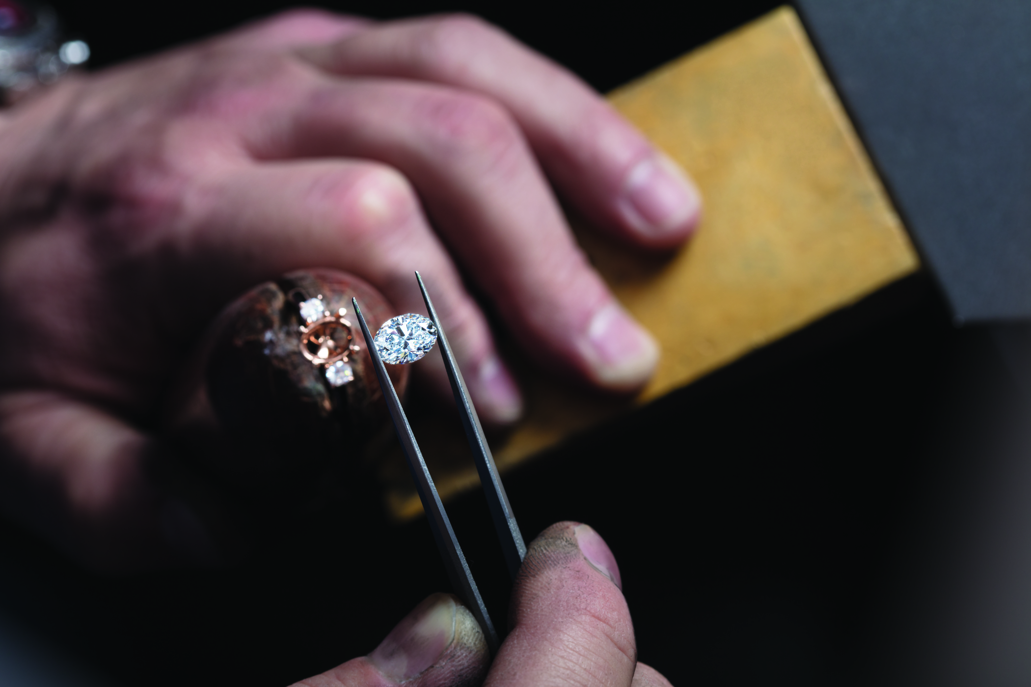 Jeweler setting a diamond