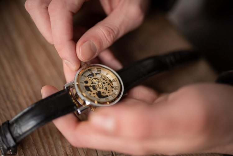 A professional performs watch repair.