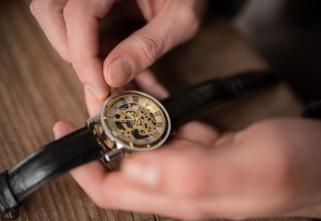 A professional performs watch repair.